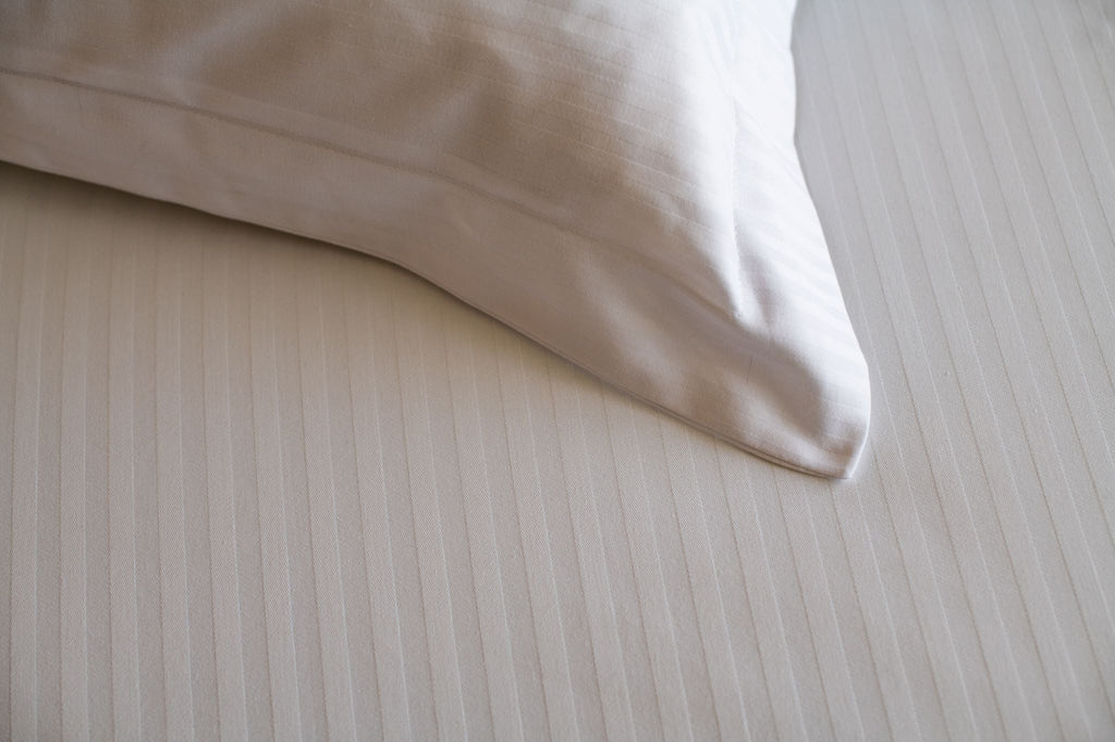 Corner of a Thomaston Mills American Luxury Lineage pillow sham on a duvet cover.